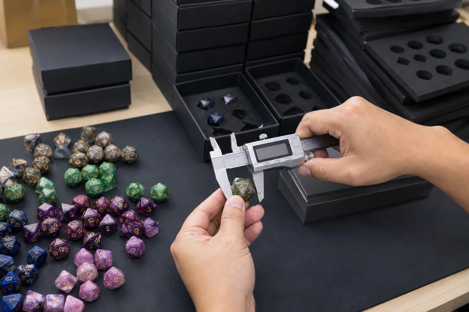 Gemstone dice inspected alongside protective presentation packaging